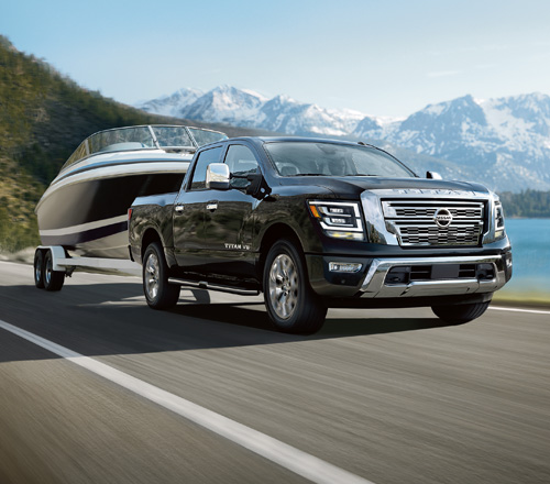 A black 2020 NIssan Titan hauling a boat