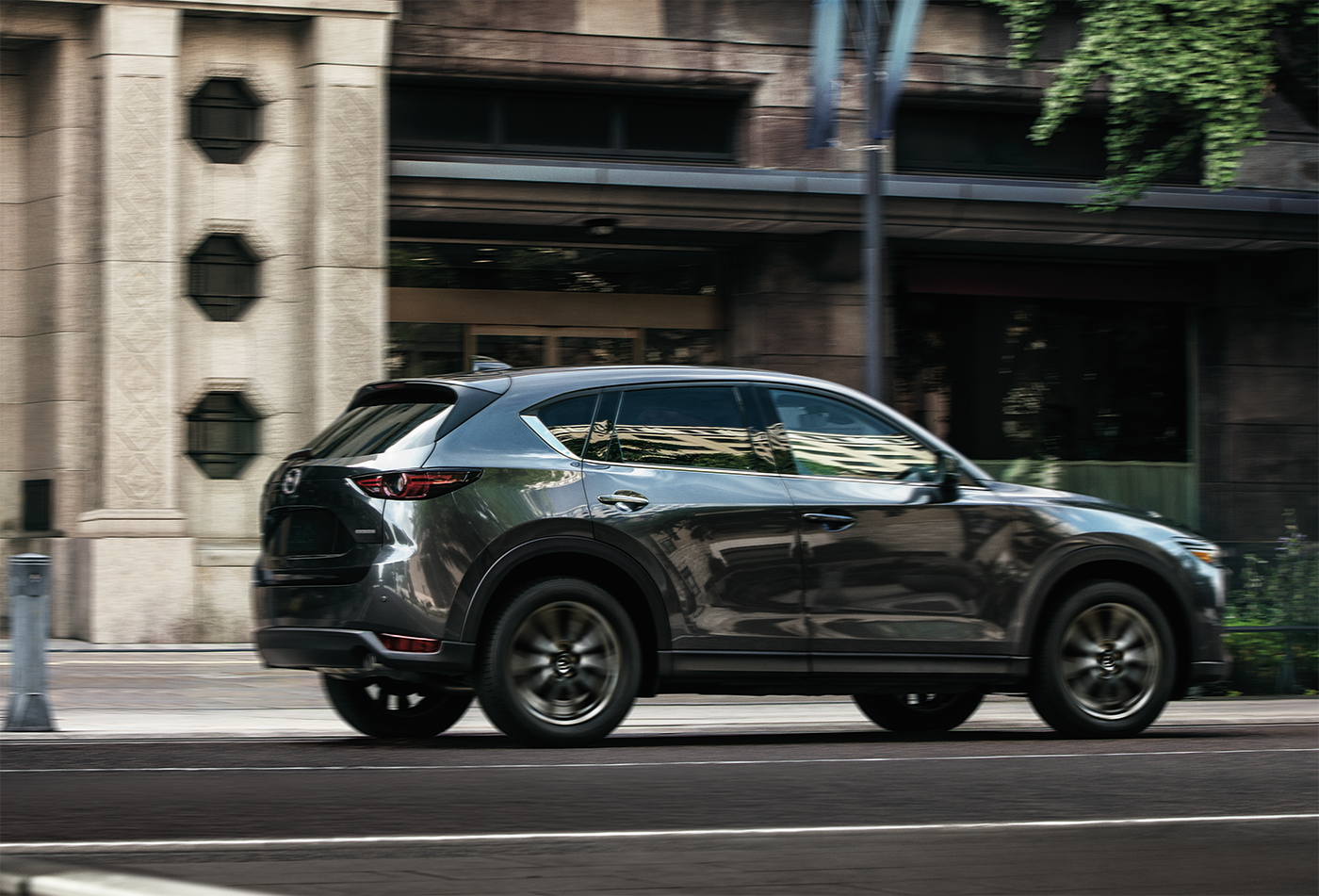 a midsize mazda driving on the road