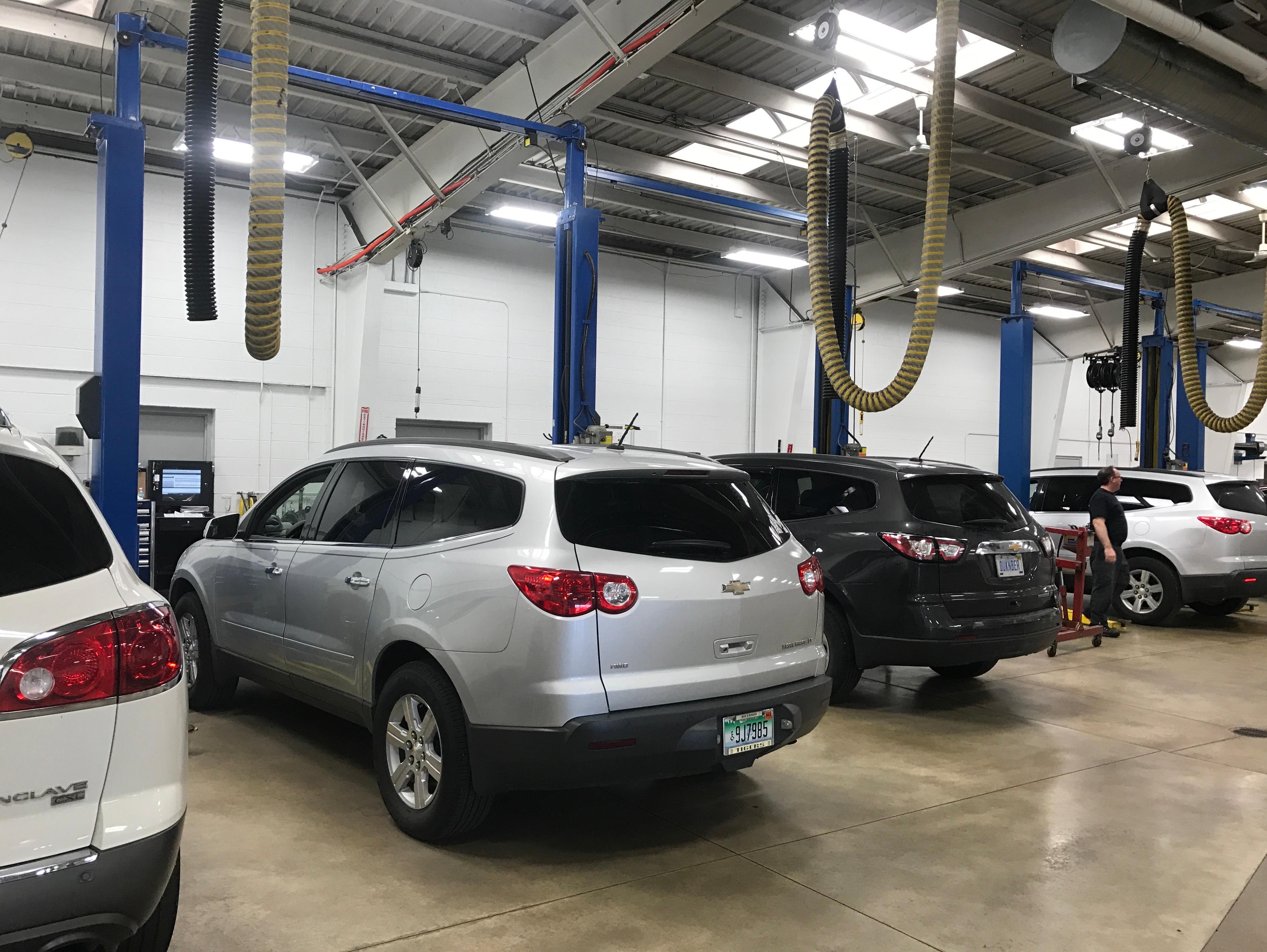 Service technician checking vehicle oil