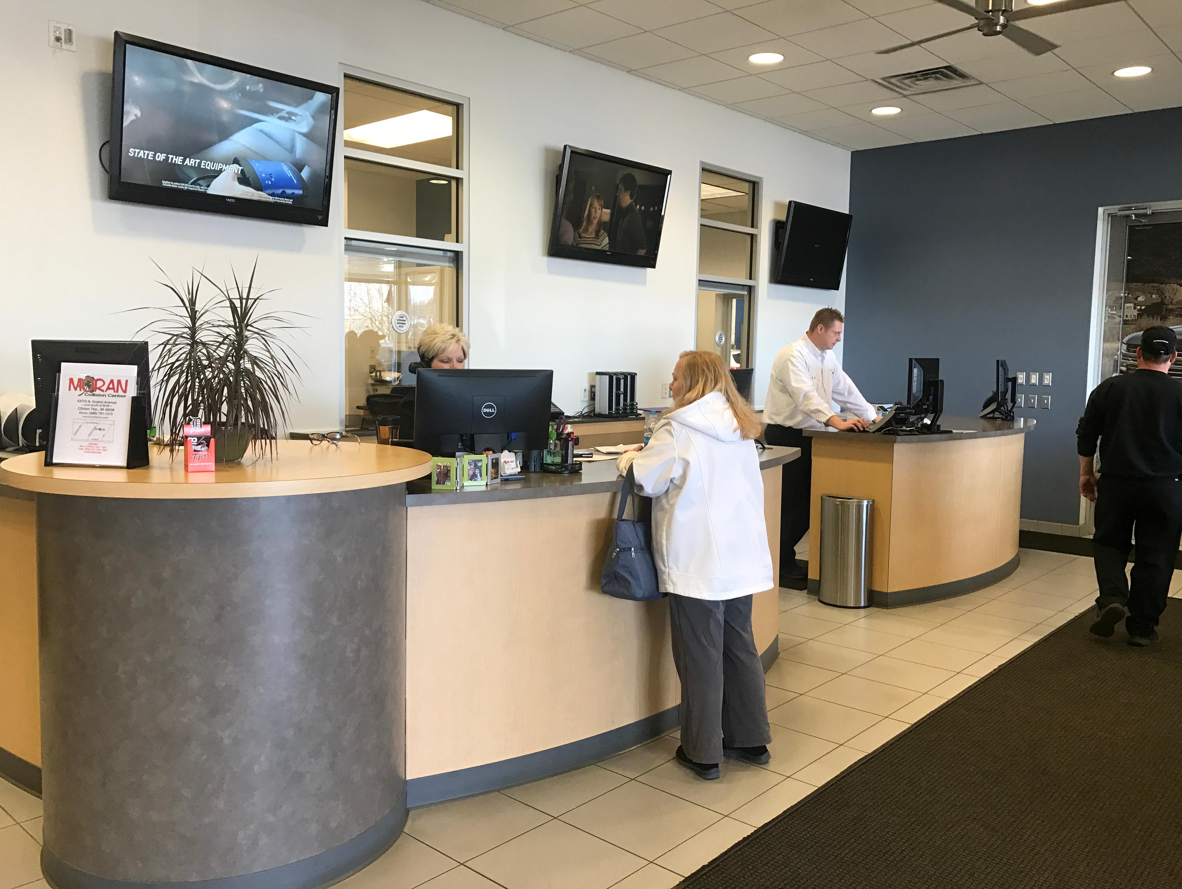  Certified Service Employee handing keys to women.