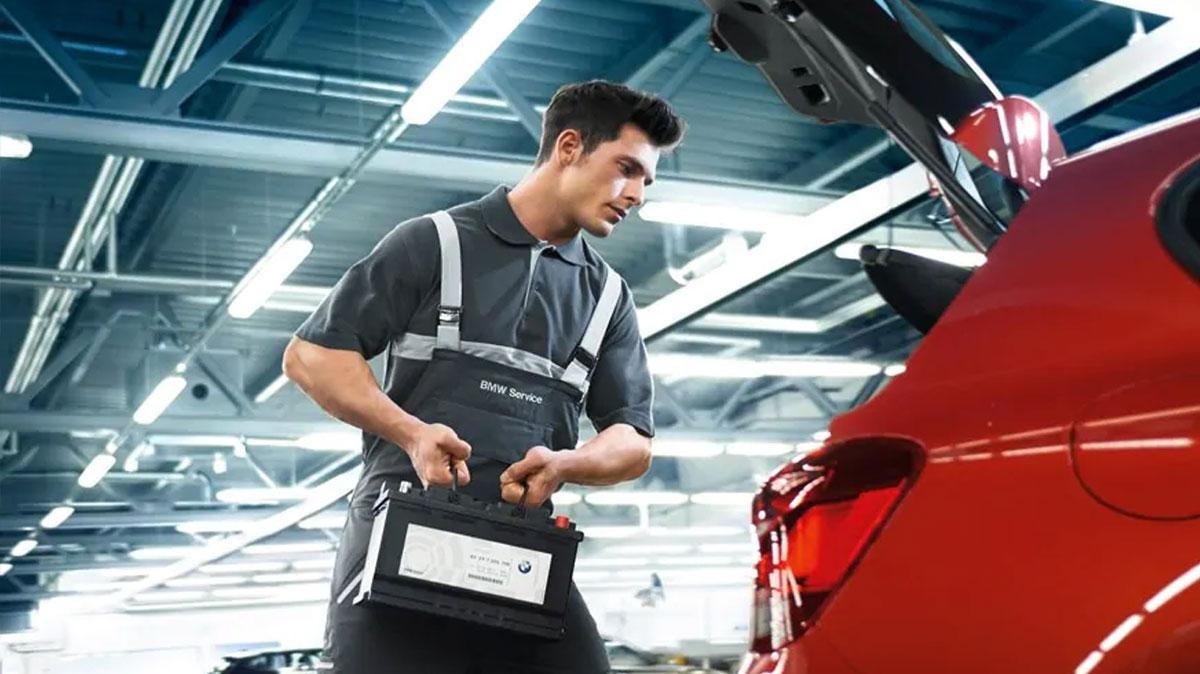 BMW ceritfied tech placing battery in car