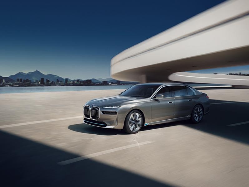 BMW i7 driving through road