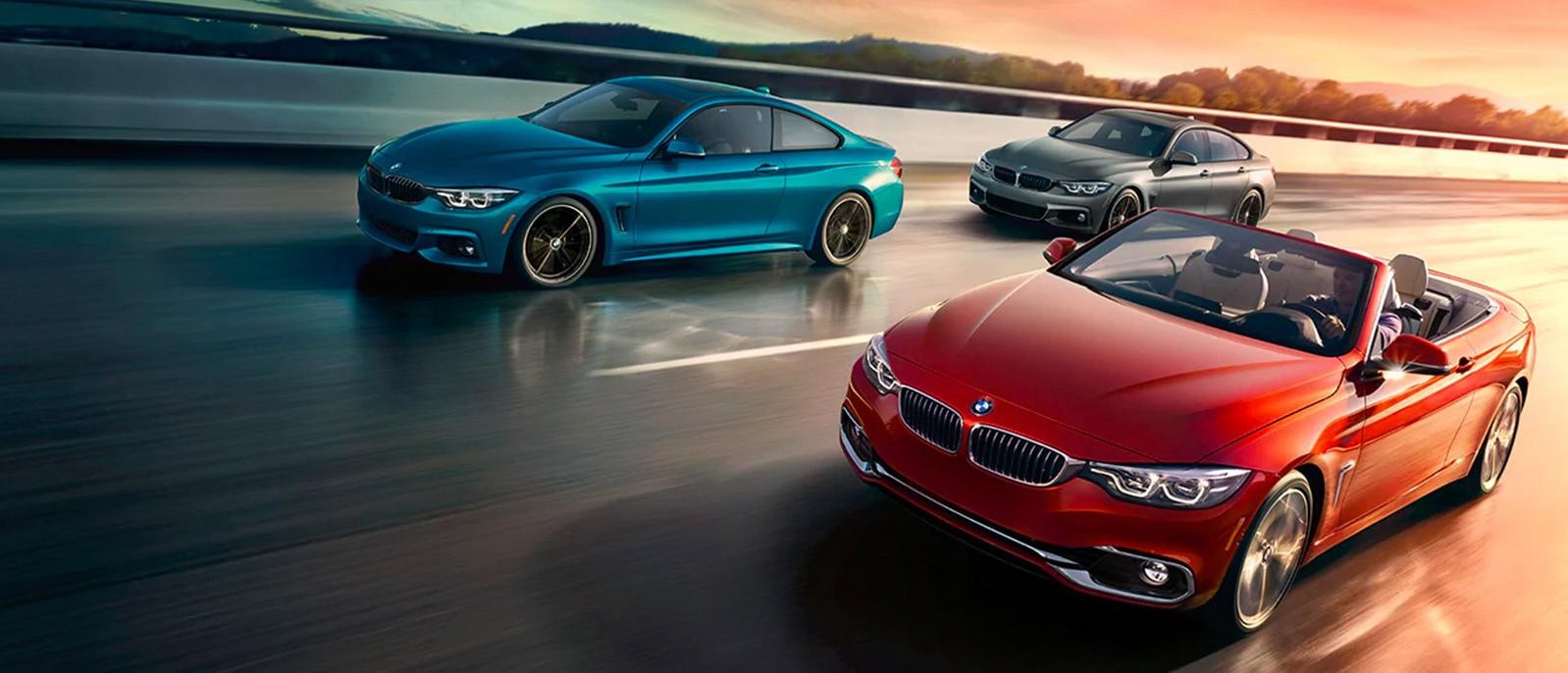 pack shot of 3 BMW 4 series vehicles driving on the road