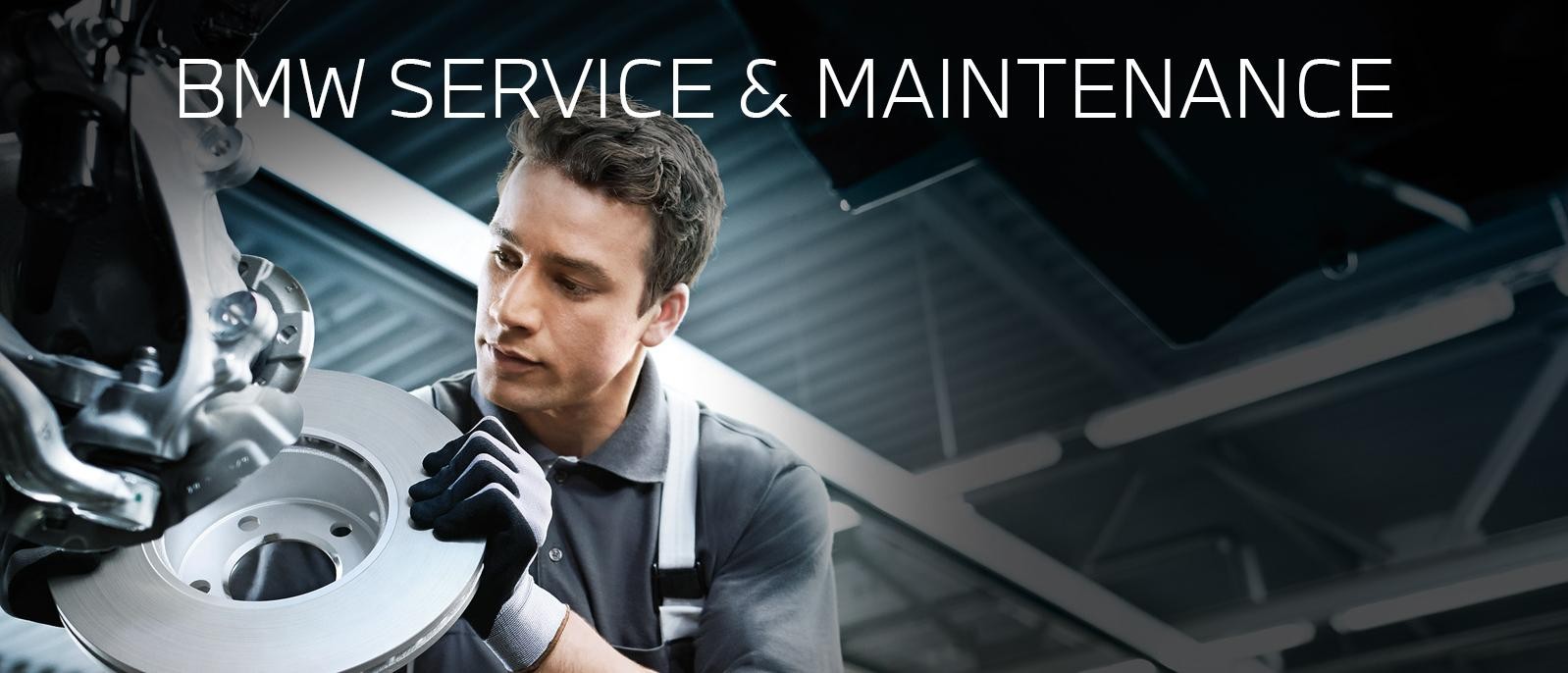 A BMW certified service technician working on a vehicle's brakes.