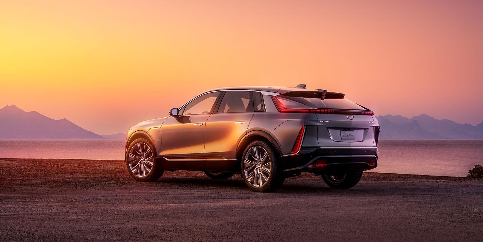 2023 Cadillac Lyriq 3/4 rear view parked on road in sunset.
