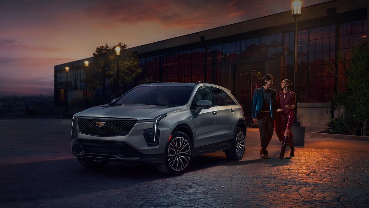 A Couple Share a Laugh as they Approach Their Cadillac XT4 During a Beautiful Sunset A Couple Share a Laugh as they Approach Their Cadillac XT4 During a Beautiful Sunset