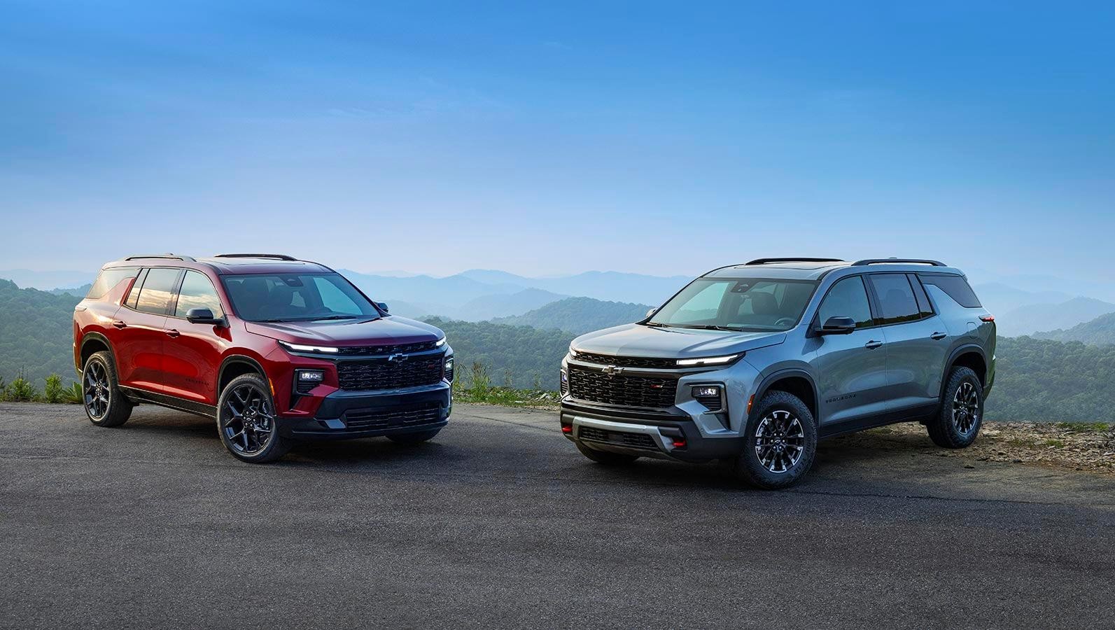 Red and grey Chevrolet Traverse facing each other. Red and grey Chevrolet Traverse facing each other.