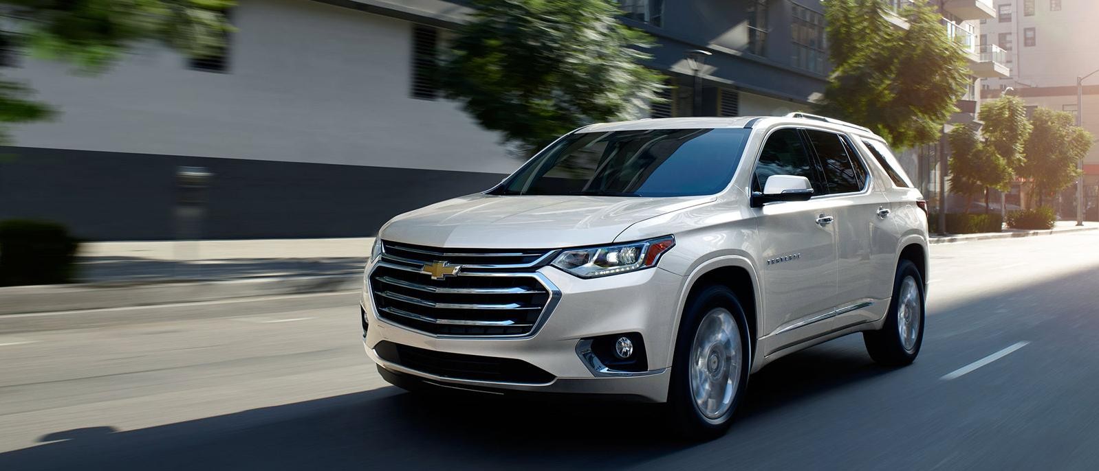 Chevrolet Traverse driving down street