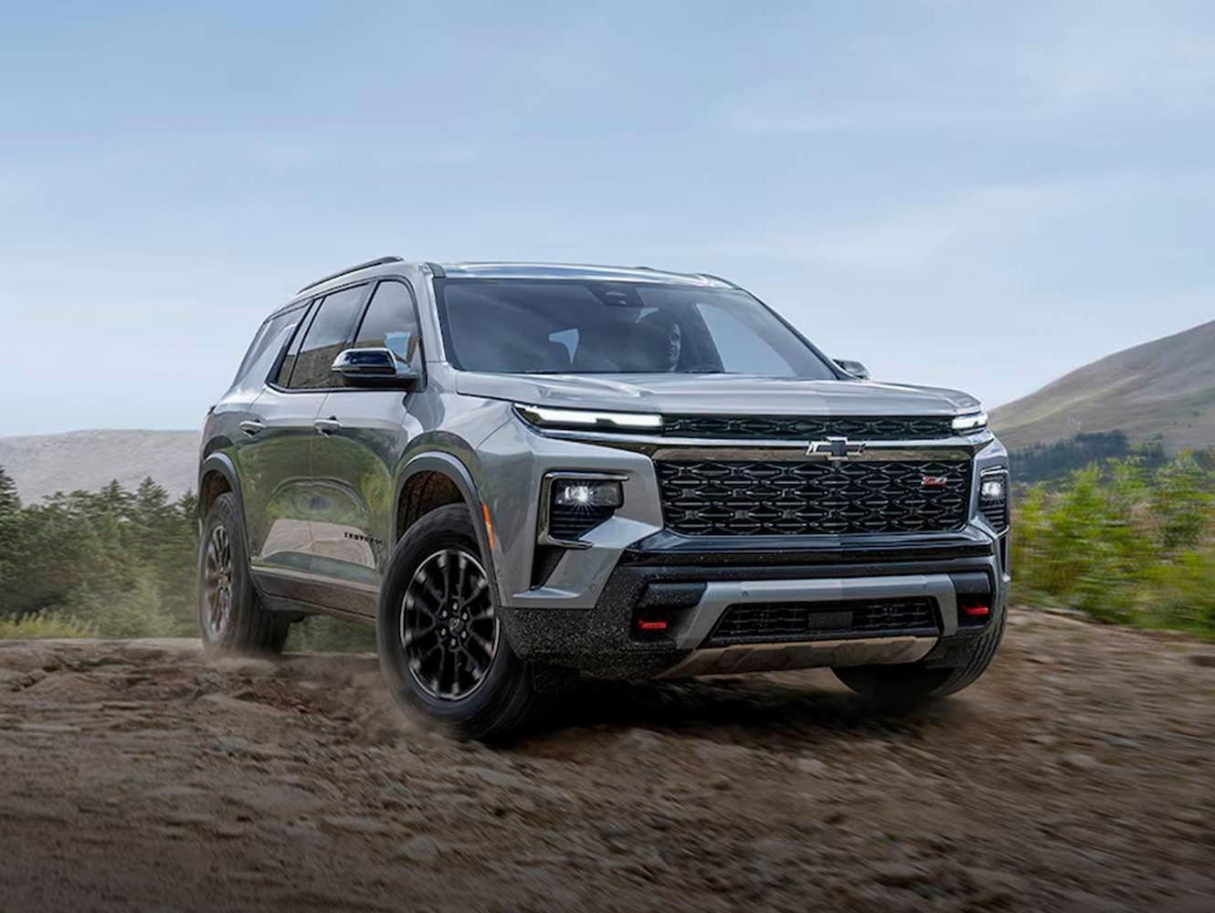 2024 Chevrolet Traverse sprinting in mountain area.