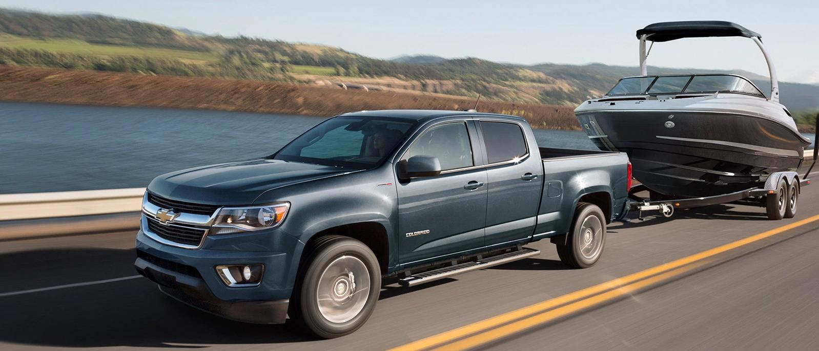 Chevrolet Colorado on a road near lake