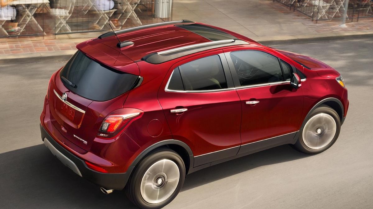 Red Buick driving on a city street