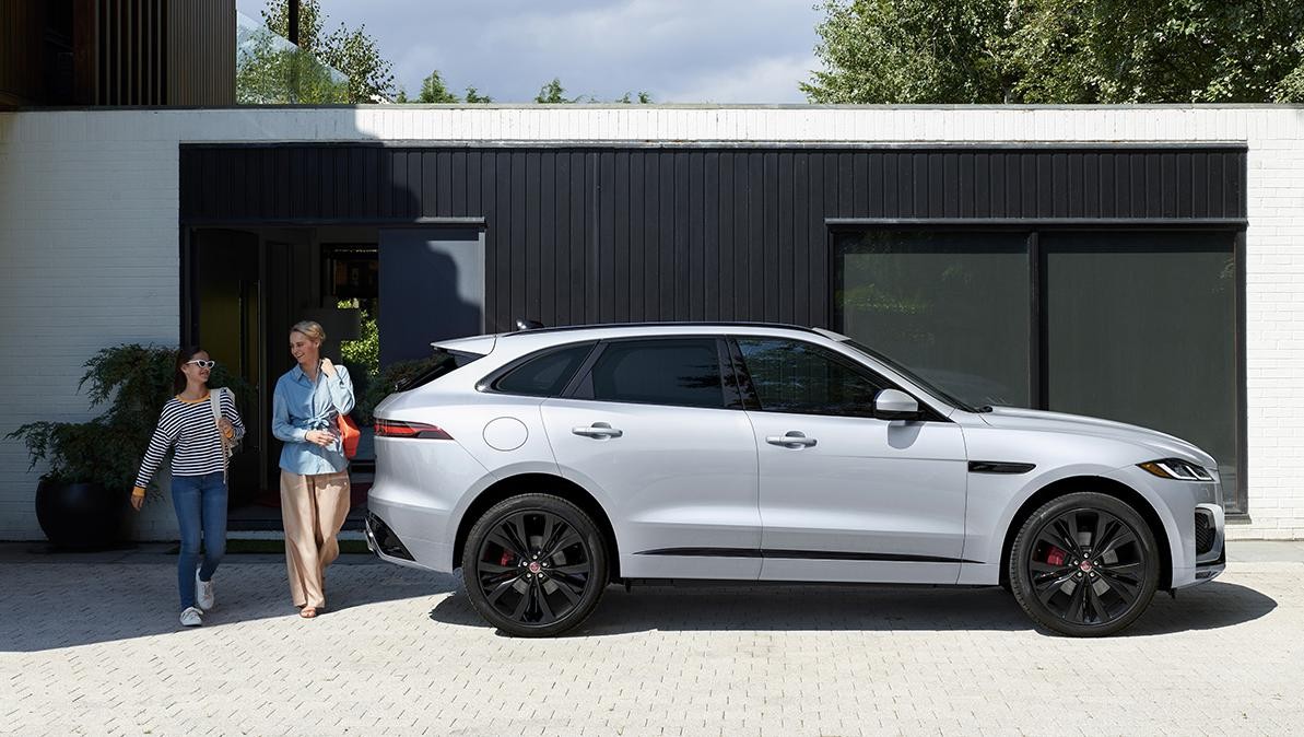 White Jaguar in front of a house