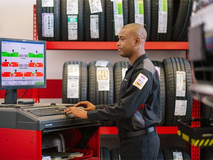 A service technician checking tire details.