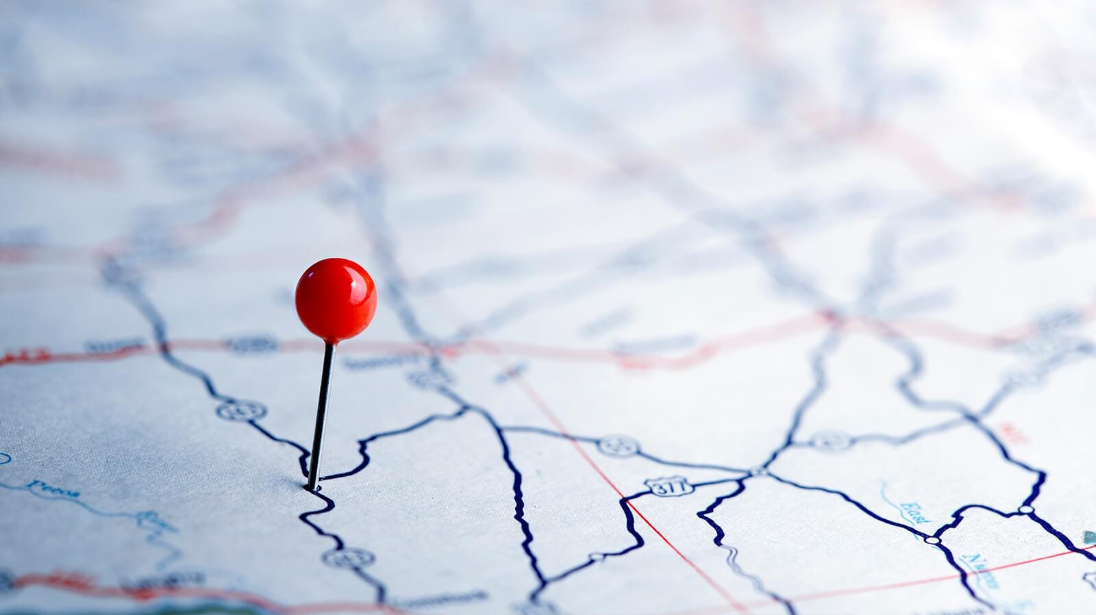 Road map with a red pin marking a destination