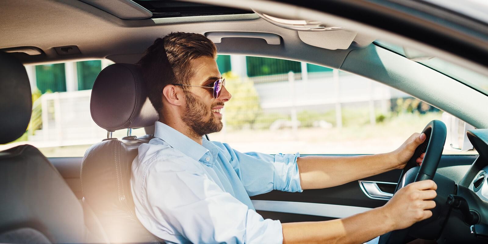 Man with sunglasses driving a car