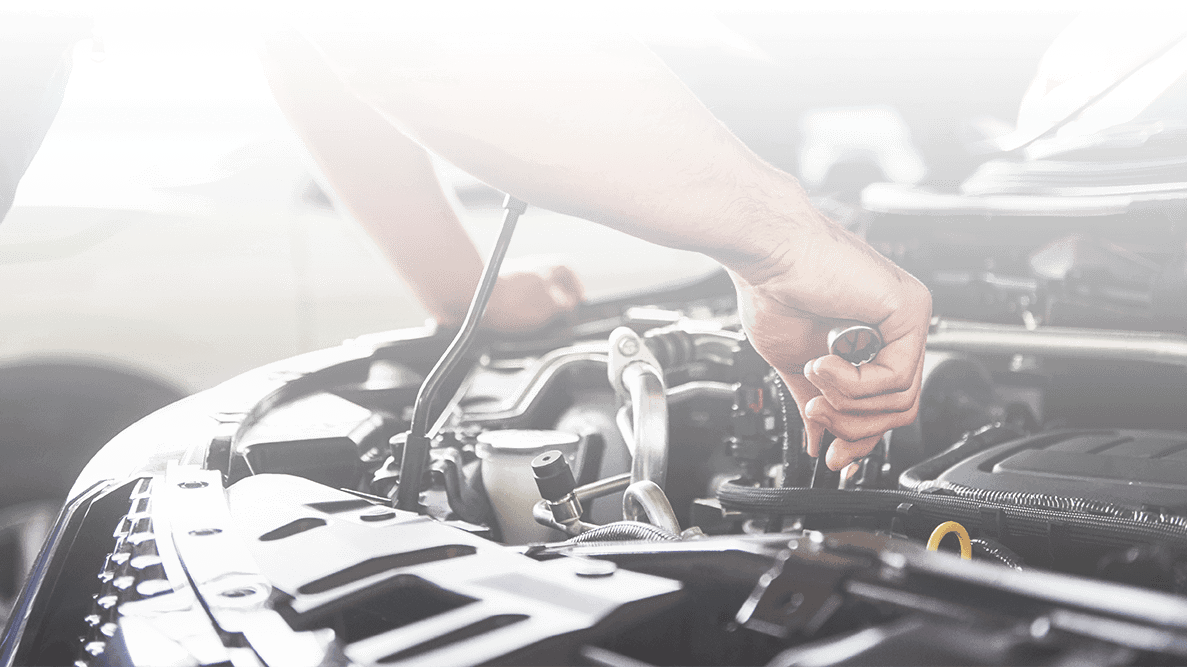 Service mechanic working on a vehicle engine