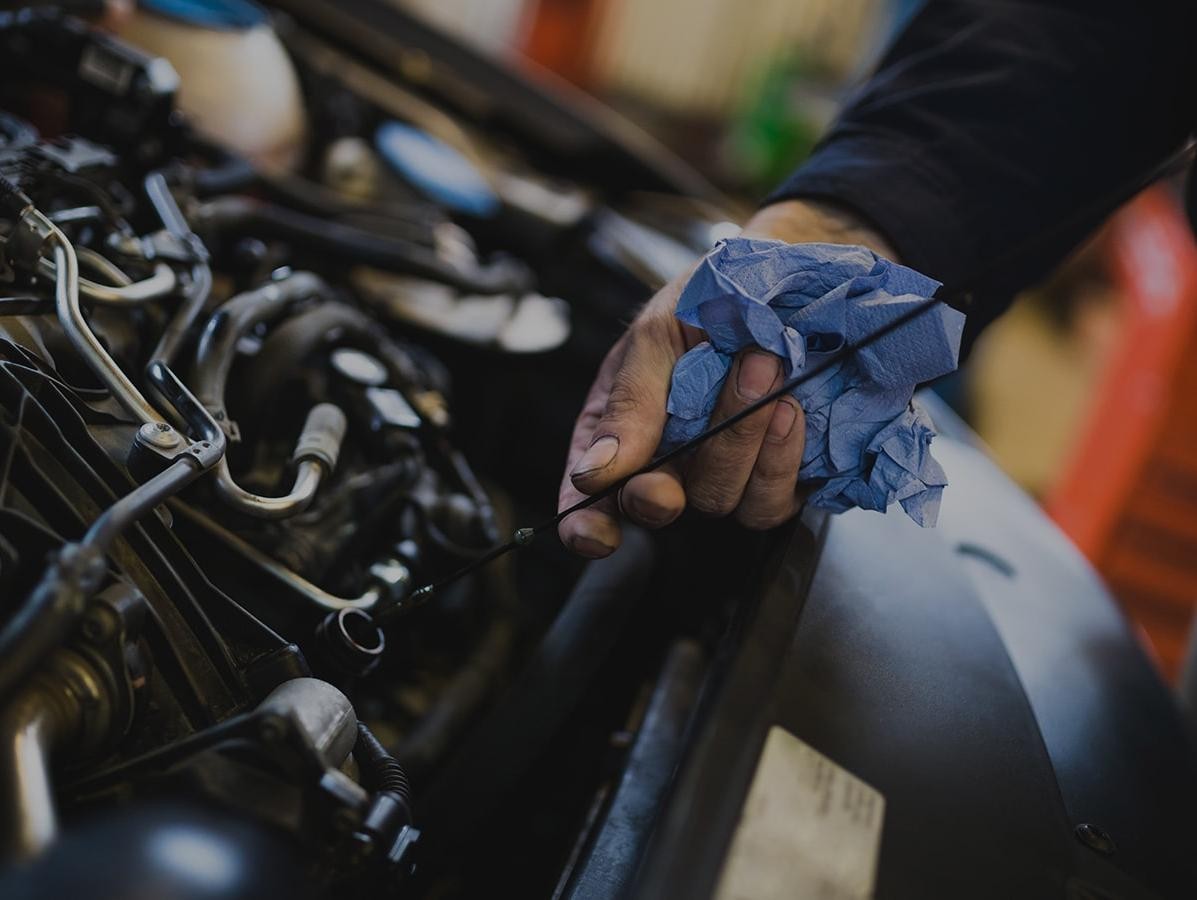 Mechanic checking an engine's oil