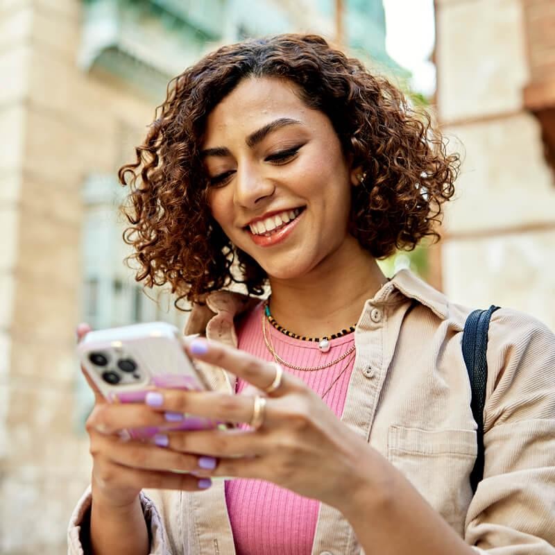 Happy girl looking at her mobile
