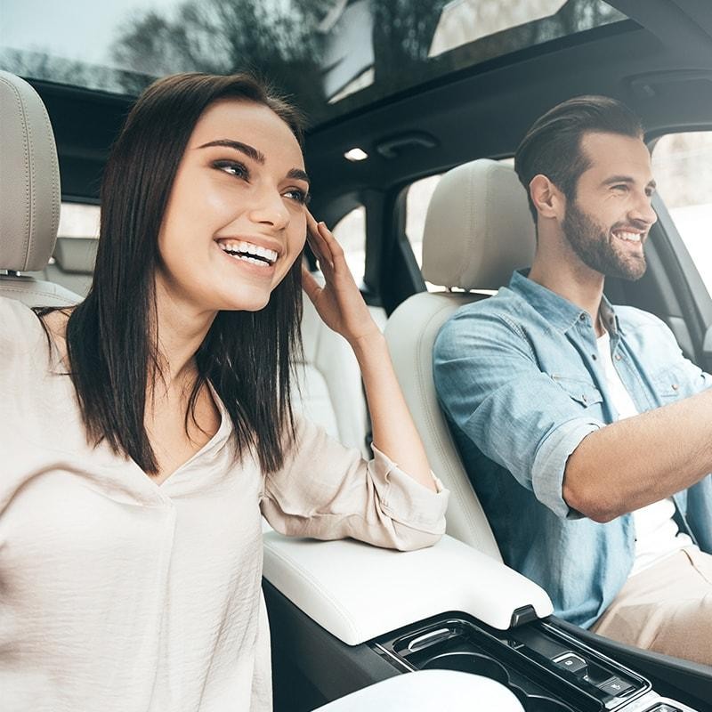 Happy couple driving in a car