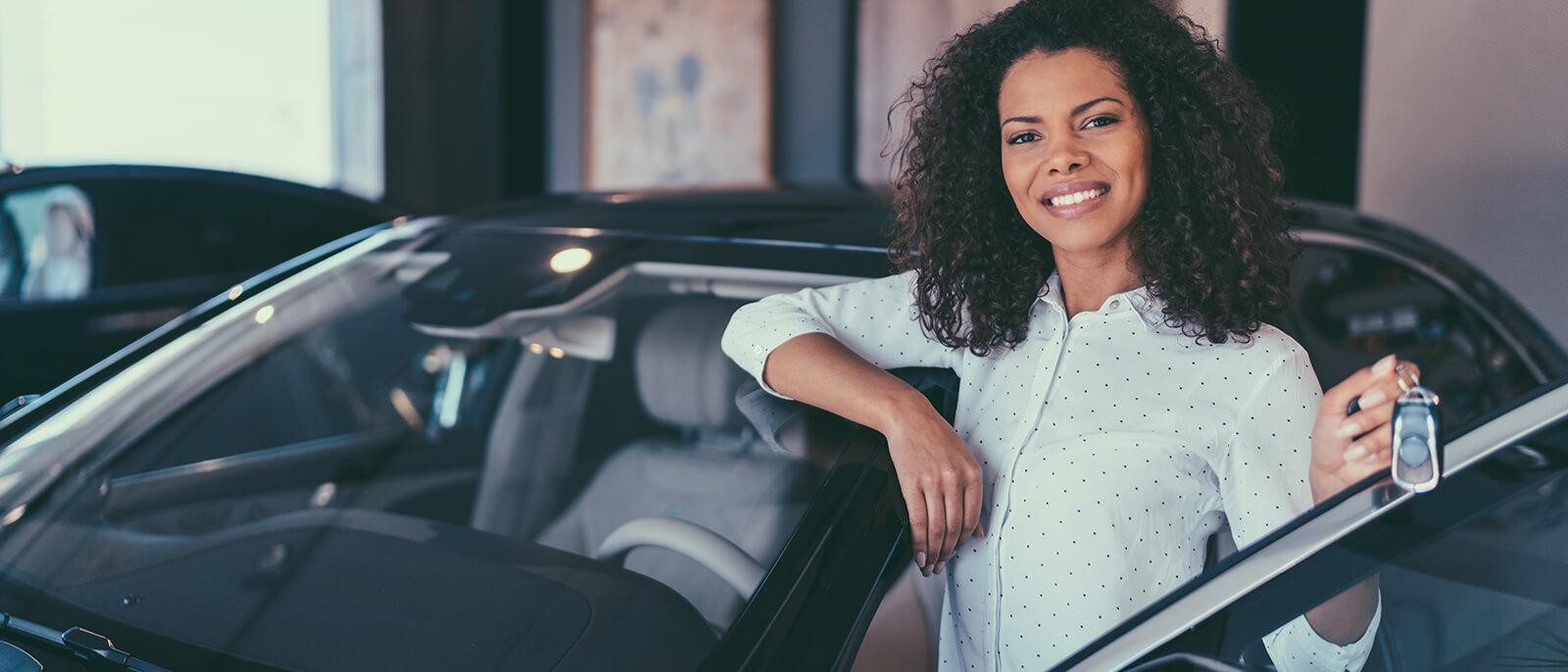 Smiling woman holding new car keys