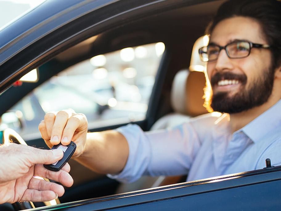 Man taking the keys to his new car