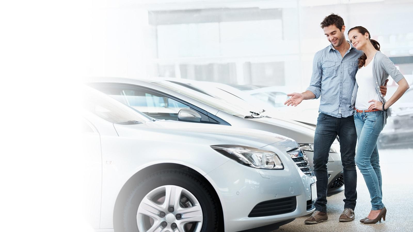 Young couple contemplating buying a new car