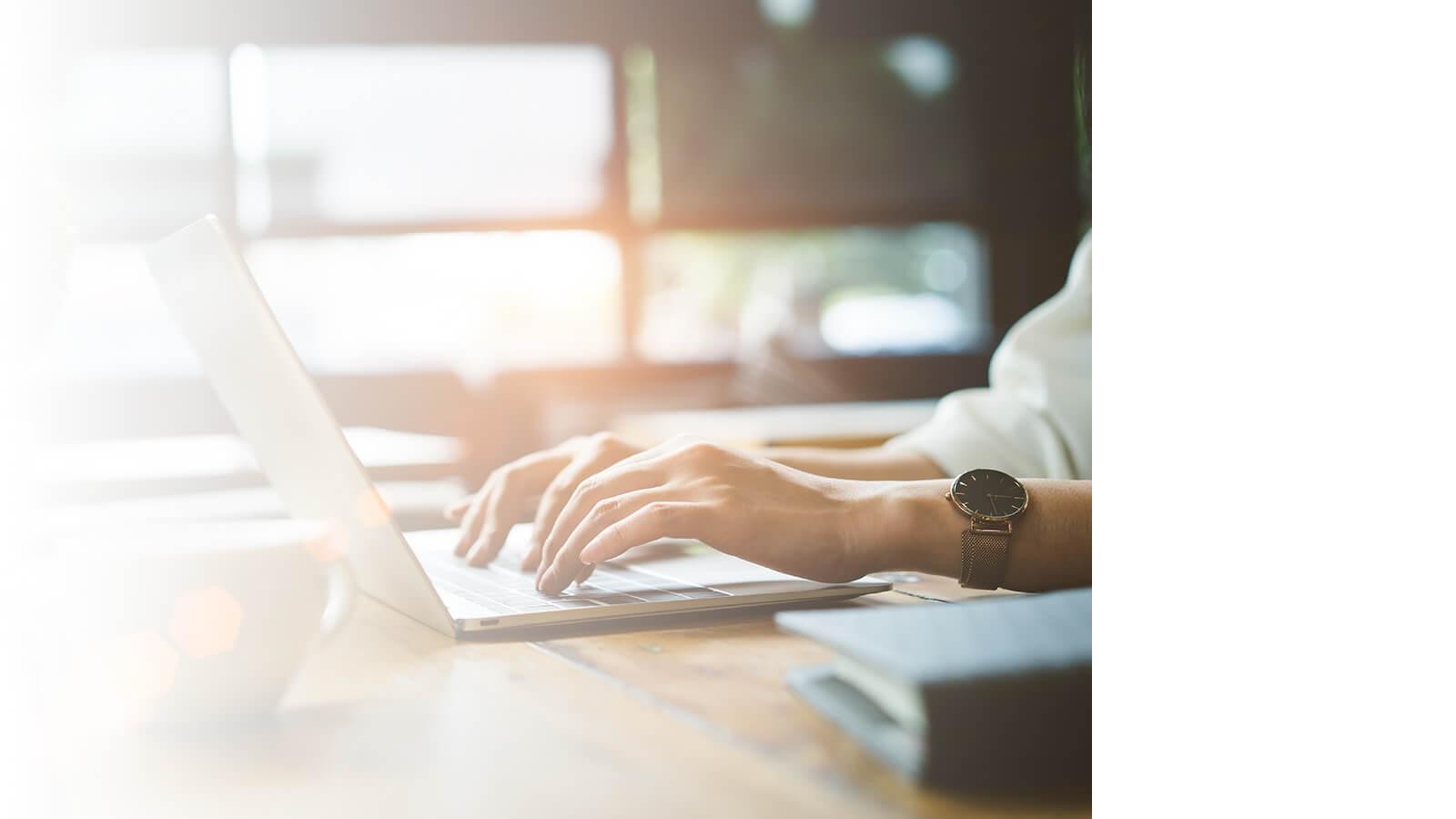 Hands using a laptop computer