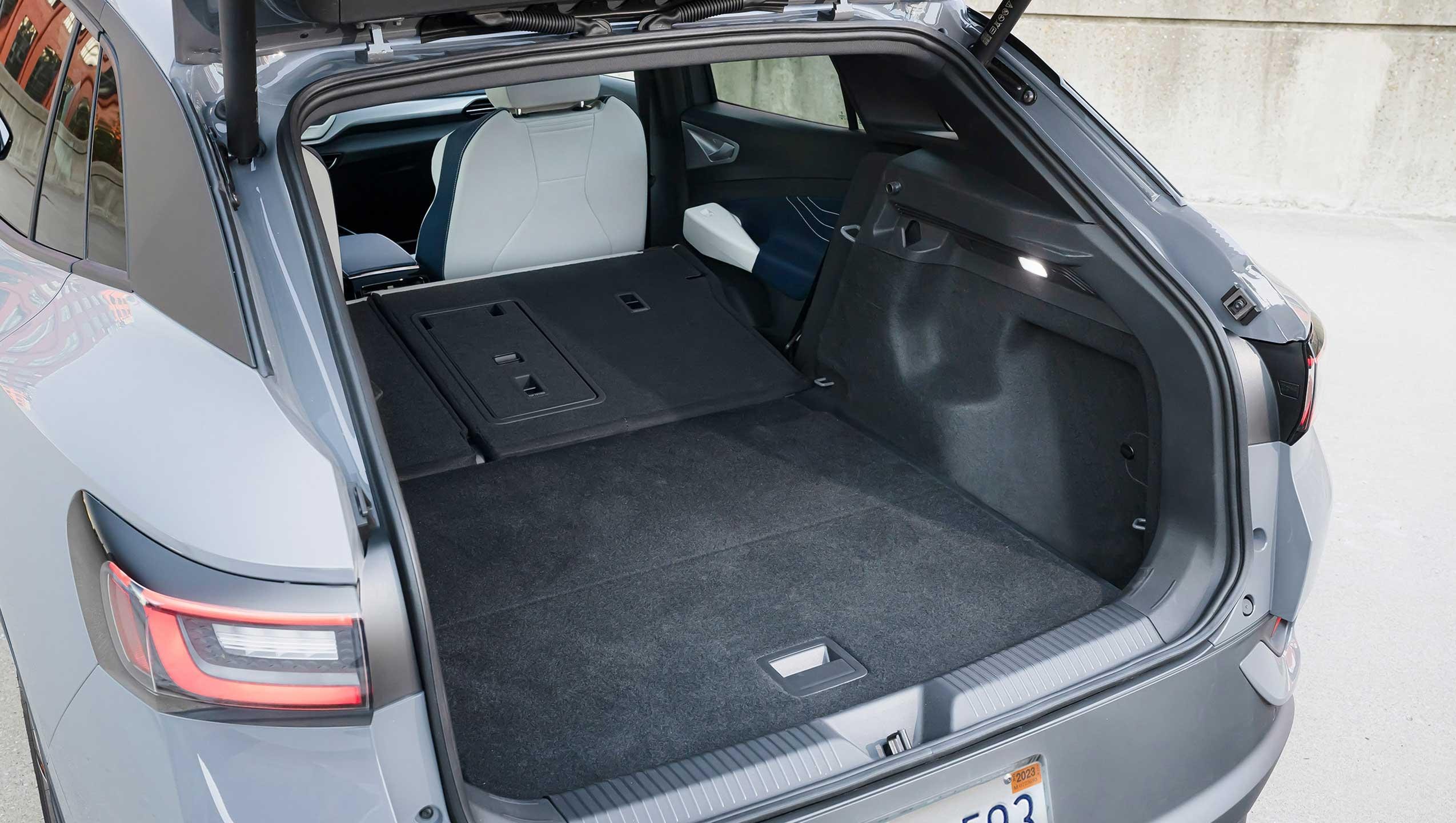 Image of a Pure Gray ID.4 showing off its cargo space with the second row folded down.
