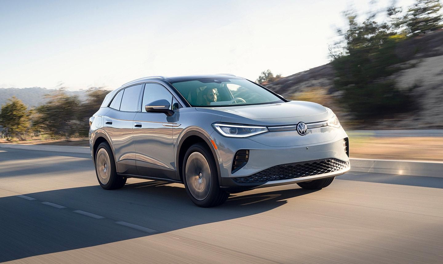 Street level shot of an ID.4 shown in Dusk Blue Metallic, parked outside a modern building.  