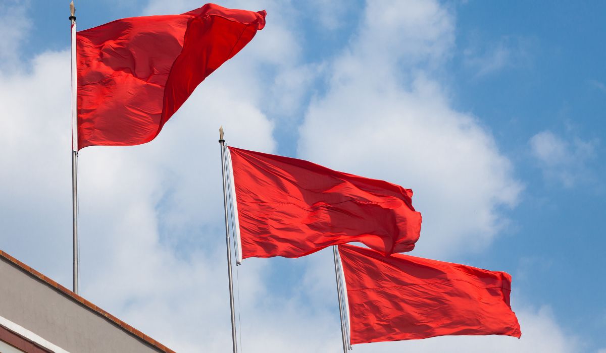 Three red flags blowing in the wind