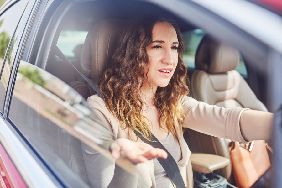 Woman frustrated by a rude driver