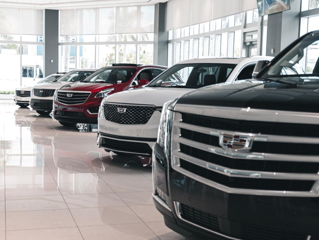 Row of new Cadillacs inside dealership