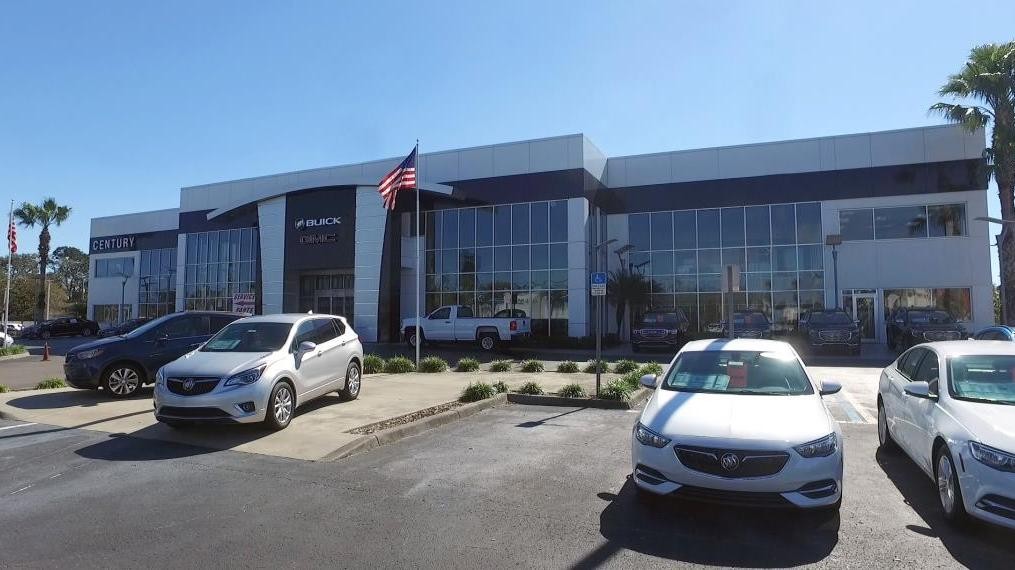 Exterior of Century Dealership with vehicles parked in front.