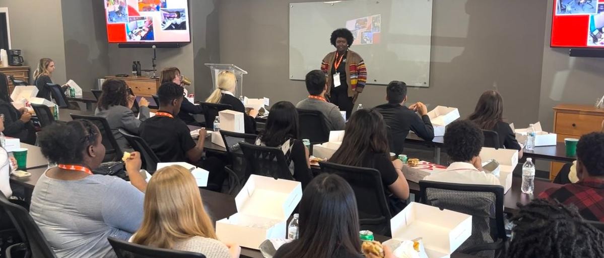 Vaden Automotive employee speaks in front of Savannah Arts Academy students