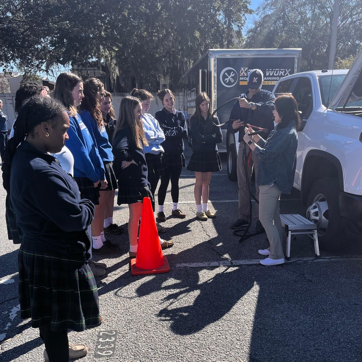 Female students from Saint Vincent's Academy surround a demonstration done by Xcel Strategies crew