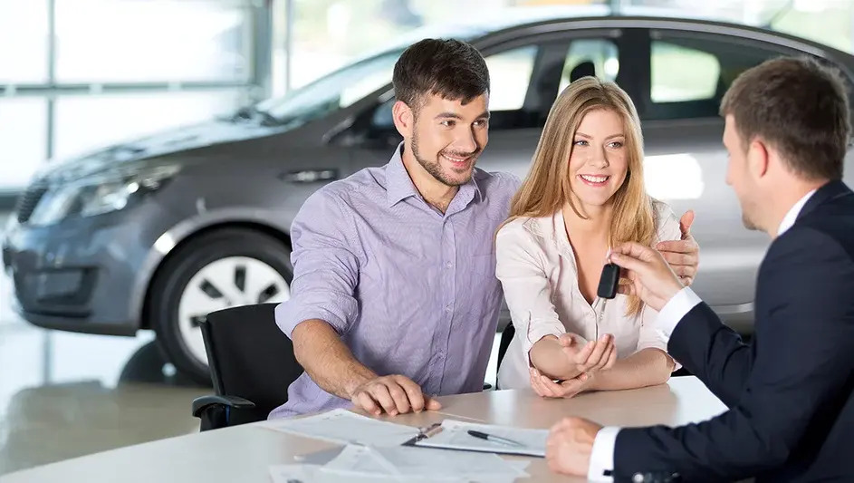 Couple leasing a car at dealership