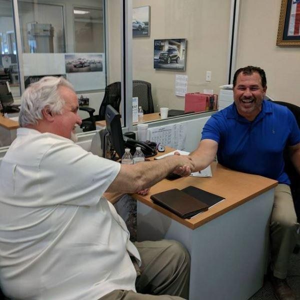 Photo of Russ Baldner, General Manager, with happy customer.