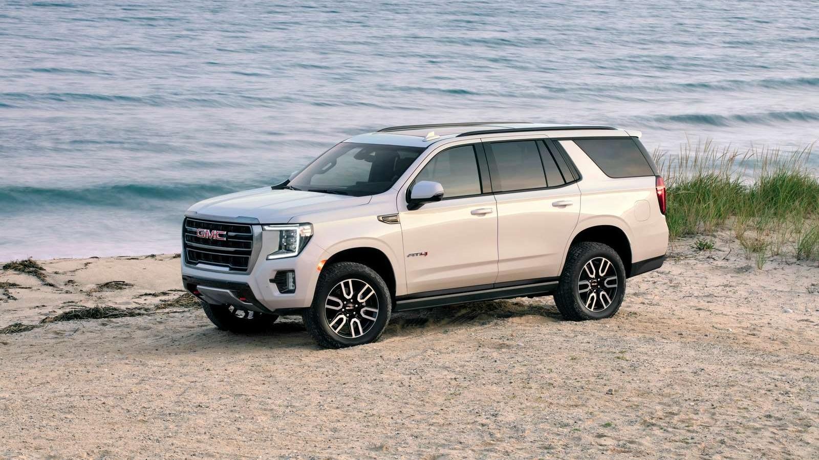 2023 GMC Yukon AT4 4WD in Summit White with (NZH) 20" 6-Spoke Machined Aluminum Wheels; 7/8 Drivers side Front; Waterfront background