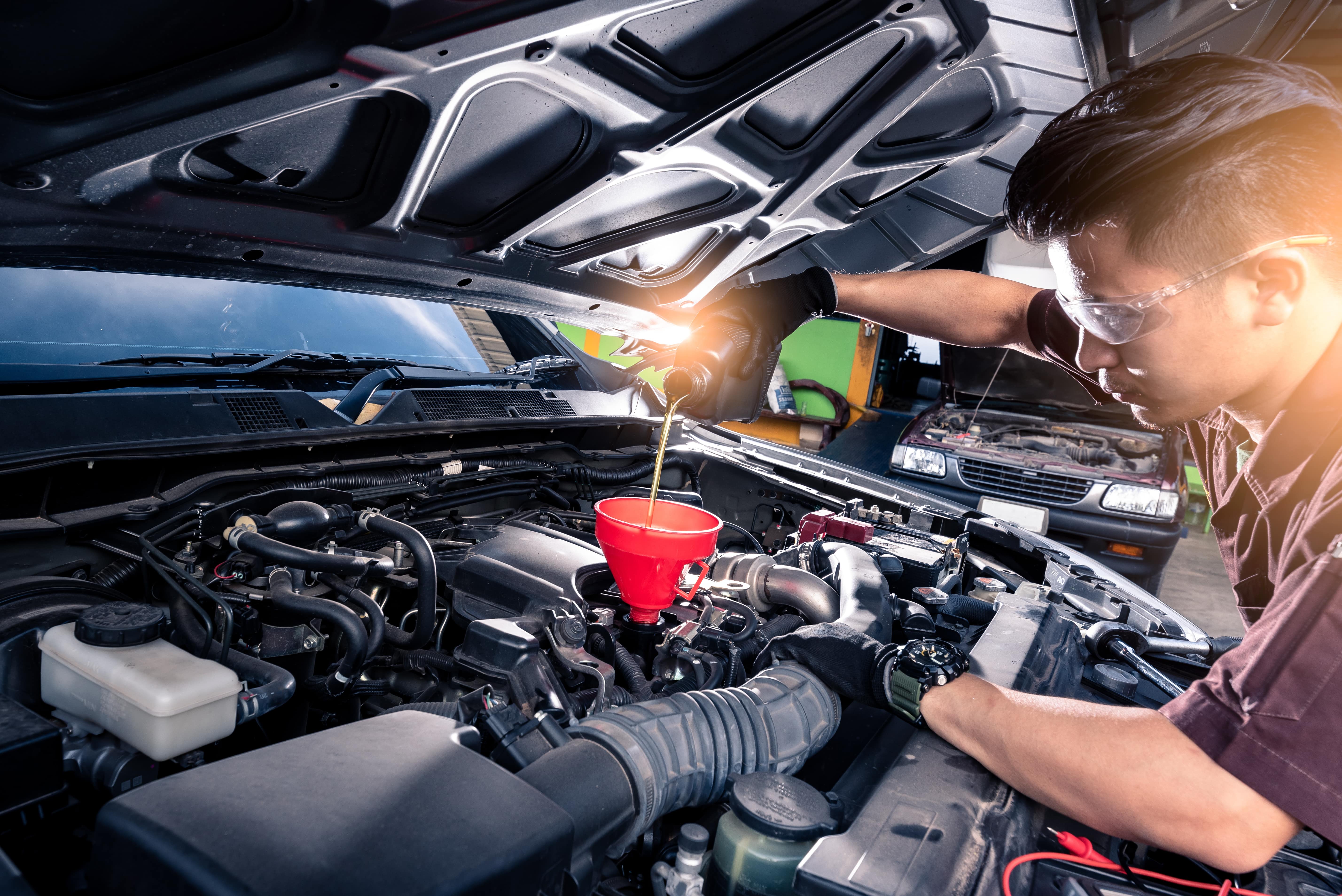 Mechanic performing an oil change on a 2025 Buick Enclave