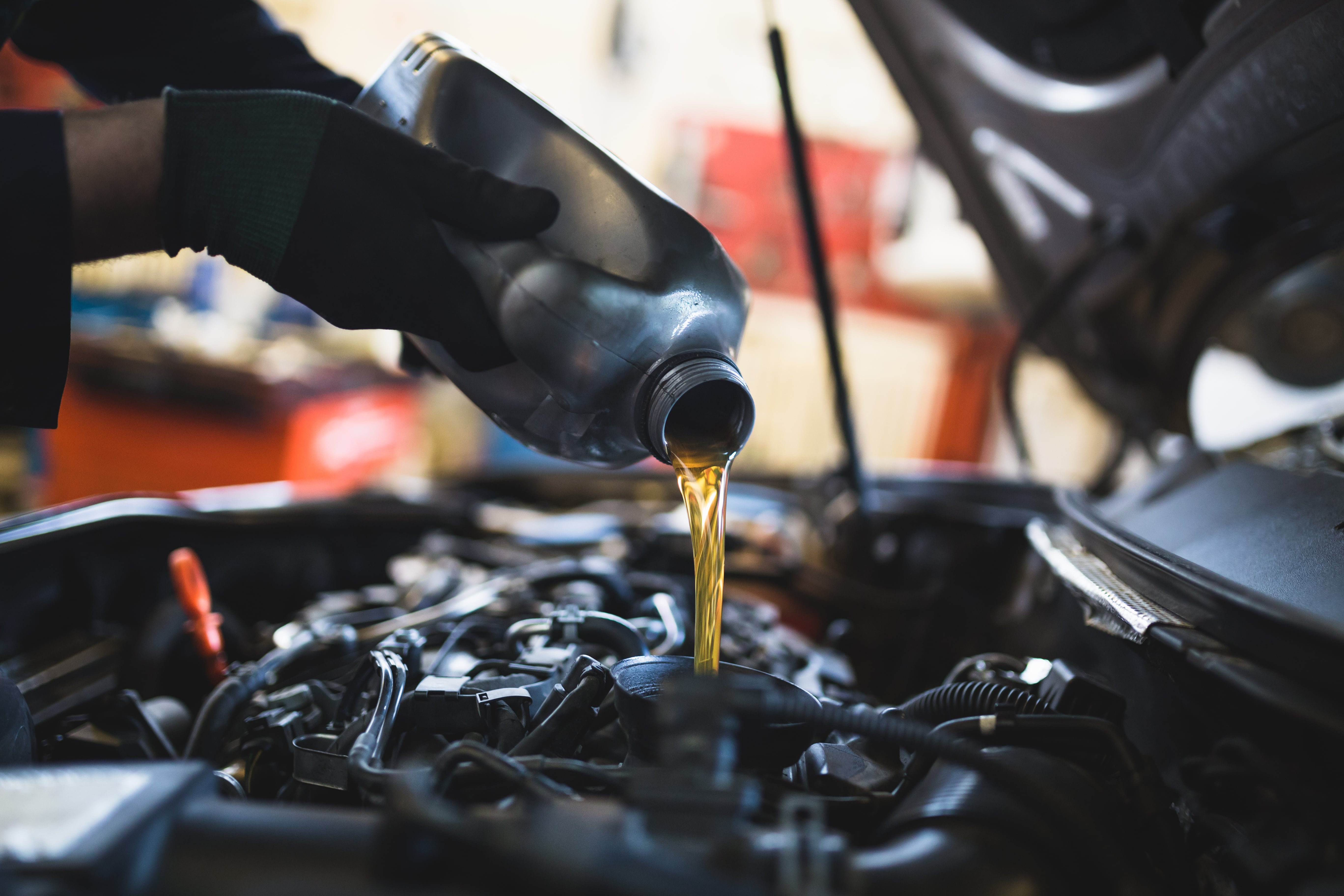 mechanic adding oil to a 2025 Buick Envision