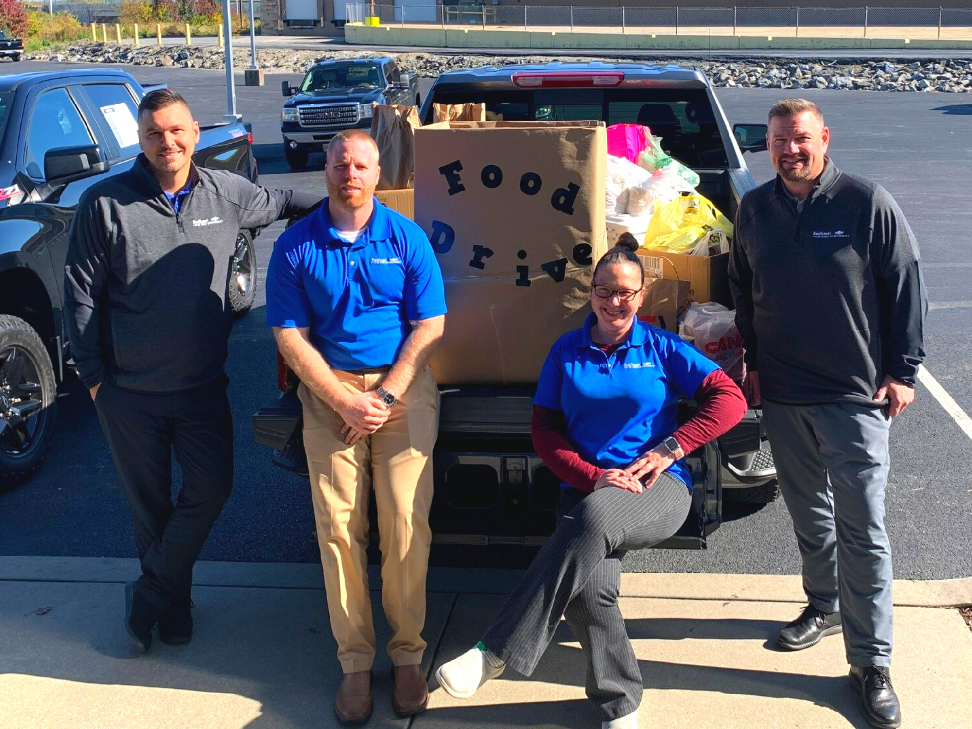 Faulkner Chevrolet employees (L-to-R) Chris Chapman, Andrew Krimmel, Eileen Culp, and President & General Manager Chad Berger, in front of the donations to fill the Silverado 1500. 