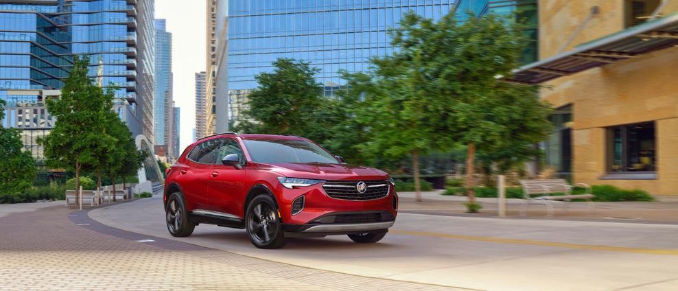 A red 2025 Buick Envision drives down the road.