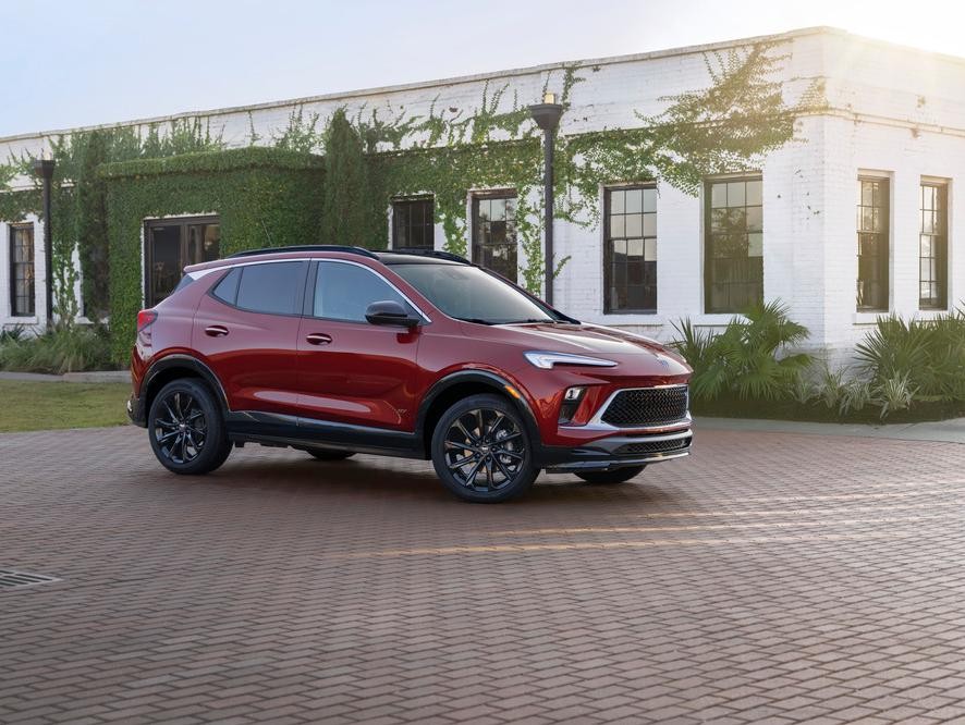 A 2025 Buick Encore GX is parked in front of a house.
