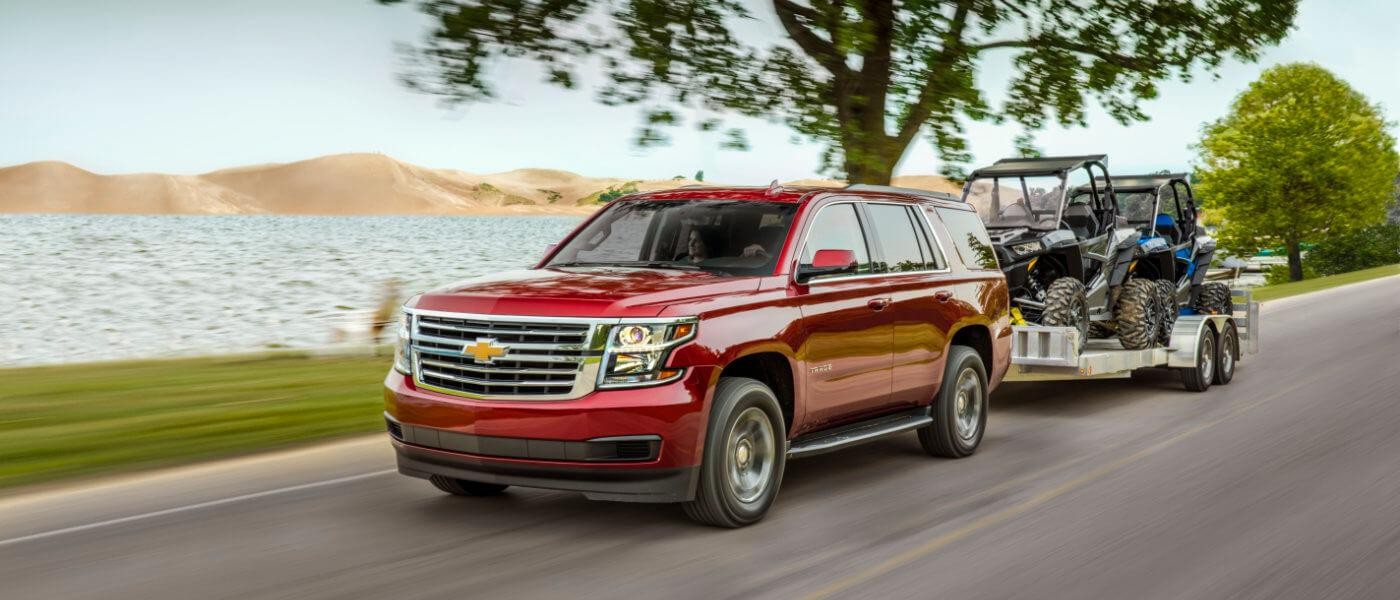 2019 Red Chevy Tahoe Towing ATVs