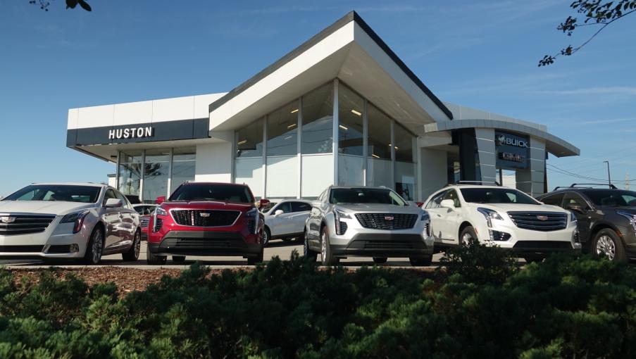 Huston dealership exterior with Cadillacs parked out front