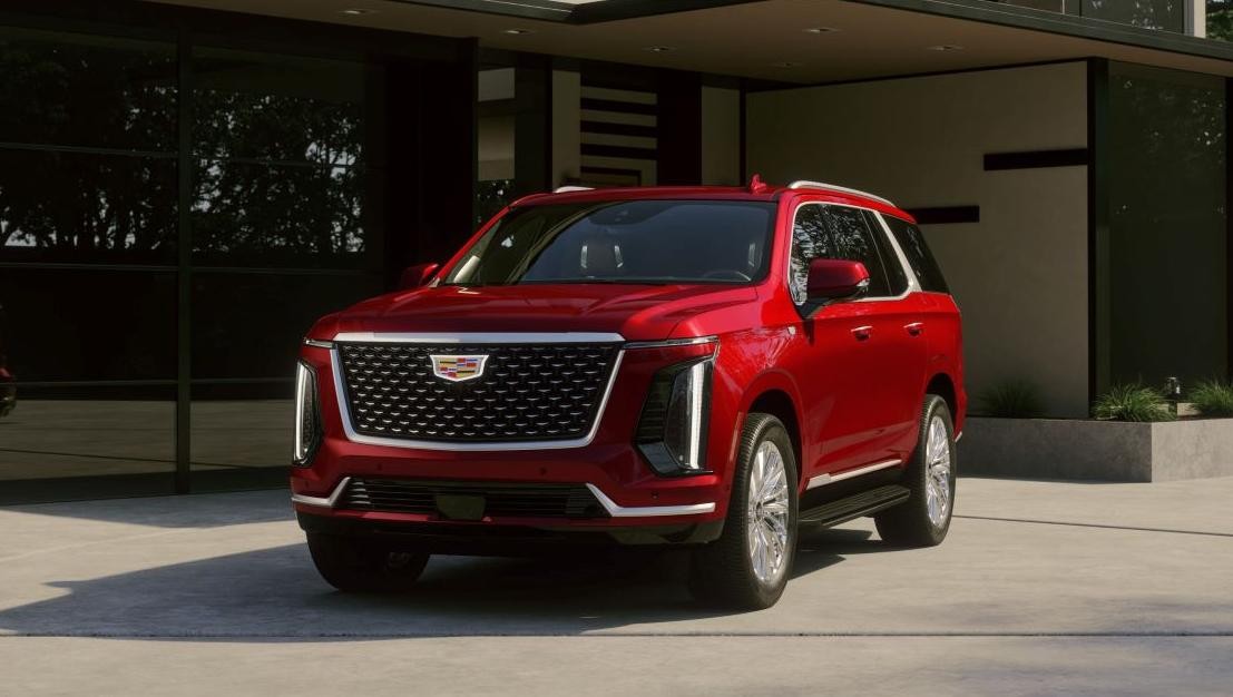 Red 2025 Cadillac Escalade in driveway outside house
