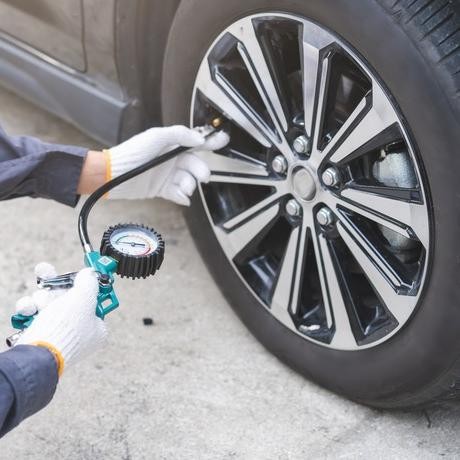 Mechanic checking the pressure on a tire
