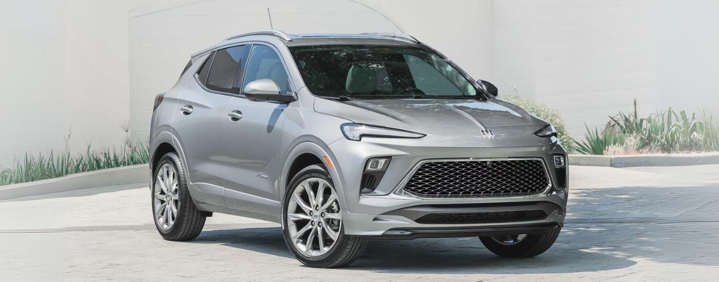 A silver 2025 Buick Encore GX Avenir is shown on concrete after leaving a Buick dealer.