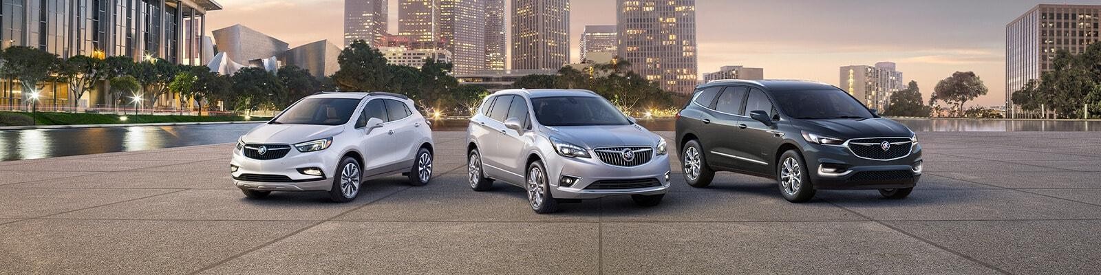 2019 Buick Encore, Envision and Enclave parked in front of a city skyline