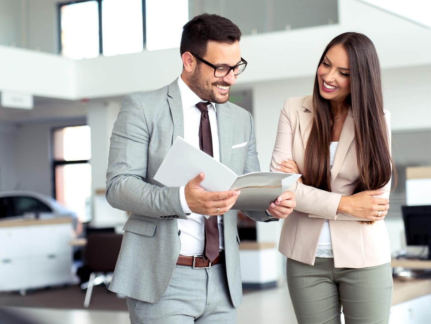Smiling couple signing finance documents